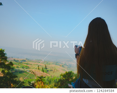 solo traveler woman sit and drink coffee with mountain view background solo traveler woman sit and drink coffee with mountain view background 124284584
