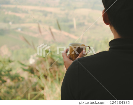 solo traveler man sit and drink coffee with mountain view background 124284585
