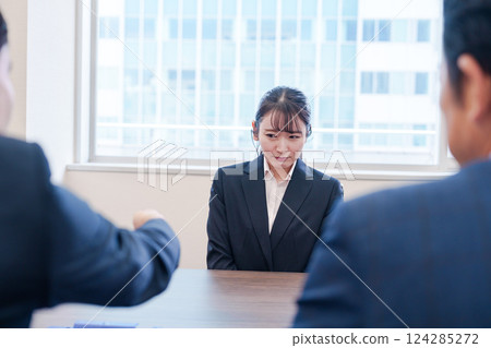 A female employee with a sad expression being scolded by her boss in the office A female employee with a sad expression being scolded by her boss in the office 124285272