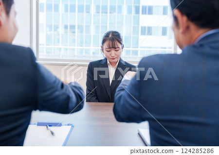 一名女員工在辦公室被老闆訓斥,表情悲傷 一名女員工在辦公室被老闆訓斥,表情悲傷 124285286