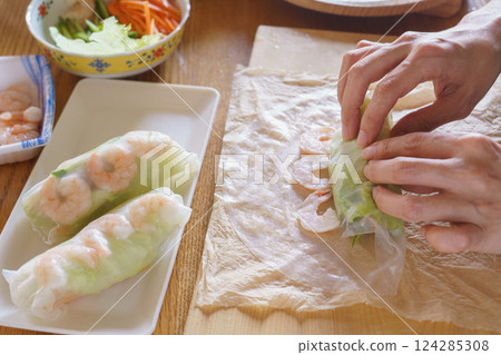 Image of wrapping shrimp and lettuce in rice paper and making fresh spring rolls Image of wrapping shrimp and lettuce in rice paper and making fresh spring rolls 124285308