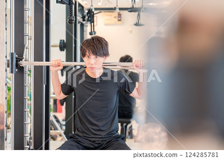 Young man working out in the gym 124285781