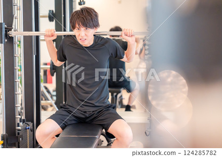 Young man working out in the gym Young man working out in the gym 124285782