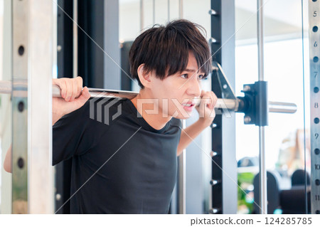 Young man working out in the gym Young man working out in the gym 124285785