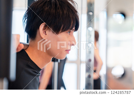 Young man working out in the gym 124285787