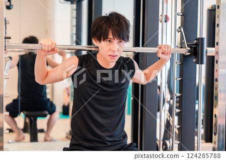 Young man working out in the gym 124285788