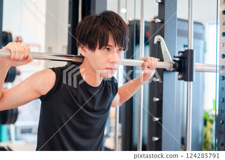 Young man working out in the gym Young man working out in the gym 124285791