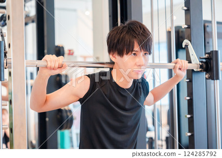 Young man working out in the gym 124285792