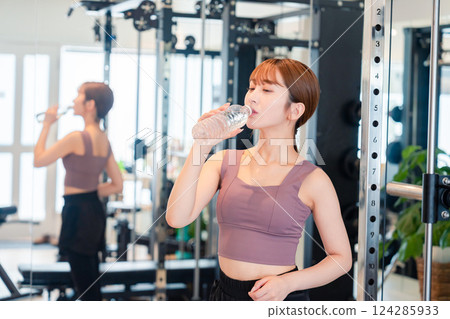 Young woman hydrating at the gym Young woman hydrating at the gym 124285933