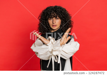 Woman says no hold palm folded crossed hands in stop gesture warning of finish prohibited access Woman says no hold palm folded crossed hands in stop gesture warning of finish prohibited access 124287472