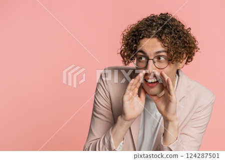 Young man whisper news rumors holding hands near mouth, share gossip, quiet, keep my secrets Young man whisper news rumors holding hands near mouth, share gossip, quiet, keep my secrets 124287501