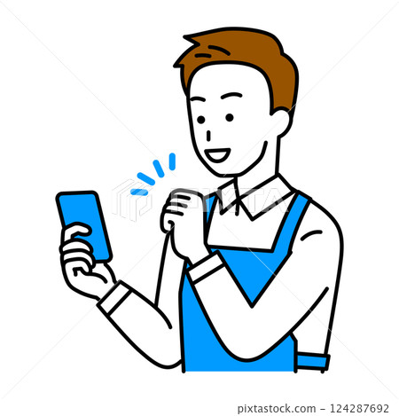A man in an apron cheering with excitement as he looks at his smartphone screen 124287692