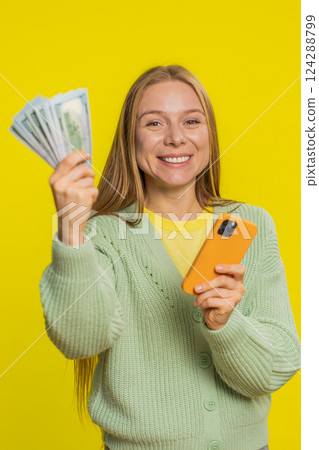 Happy woman use smartphone rejoicing game win, receiving money dollar cash, celebrating success 124288799