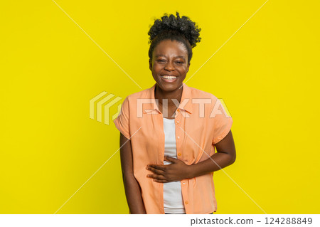 Amused smiling cheerful Black woman laughing out loud funny ridiculous joke anecdote bullying abuse 124288849