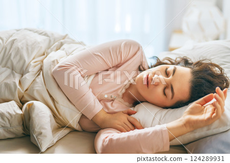 Woman is sleeping in her bedroom Woman is sleeping in her bedroom 124289931