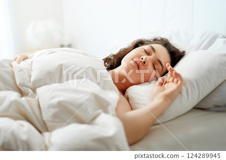 Woman is sleeping in her bedroom Woman is sleeping in her bedroom 124289945