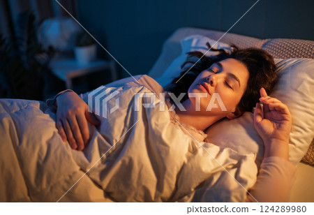 Woman is sleeping in her bedroom Woman is sleeping in her bedroom 124289980