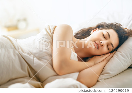 Woman is sleeping in her bedroom Woman is sleeping in her bedroom 124290019