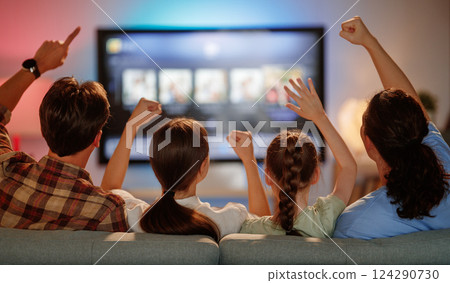 family watching  TV in the evening at home 124290730