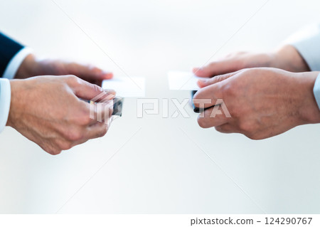Businessman and engineer exchanging business cards, no faces Businessman and engineer exchanging business cards, no faces 124290767