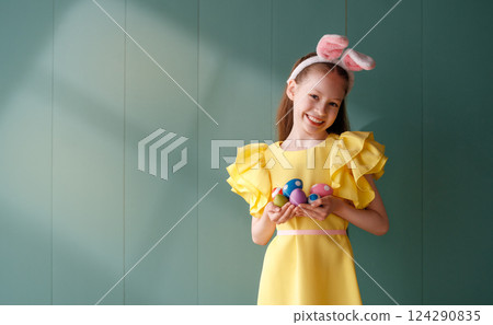 Girl with painted eggs 124290835
