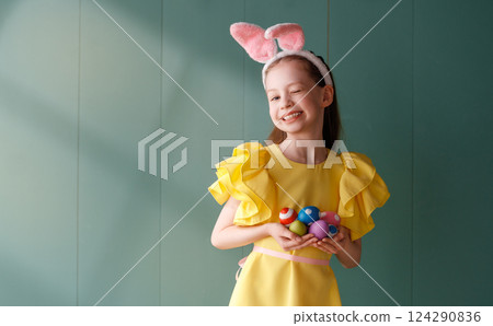 Girl with painted eggs 124290836
