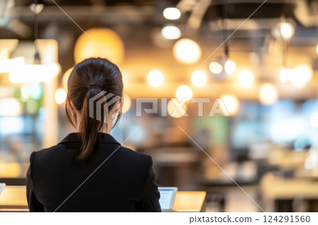 Back view of a woman working in a cafe 124291560