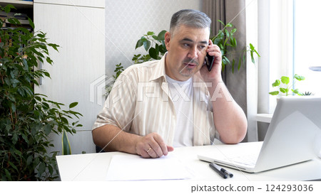 Man on Phone Having a Tense Conversation Man on Phone Having a Tense Conversation 124293036