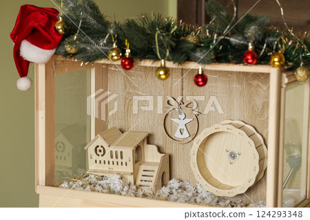 Hamster Wooden Cage Decoration Christmas. Small pet Hamster natural wooden house. Arranging decoration of hamster cage Hamster Wooden Cage Decoration Christmas. Small pet Hamster natural wooden house. Arranging decoration of hamster cage 124293348
