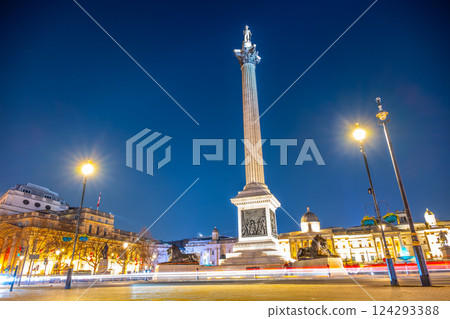 Nelson's Column stands tall in Trafalgar Square at night, illuminated by street lights. The monument commemorates Vice-Admiral Horatio Nelson's victory at the Battle of Trafalgar. 124293388
