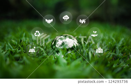 Environment and nature conservation glass ball on grass showing the world and surrounding environment icons 124293736