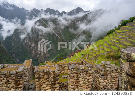 Panoramic view of Machu Picchu ruins surrounded by misty mountains, Peru Panoramic view of Machu Picchu ruins surrounded by misty mountains, Peru 124293888