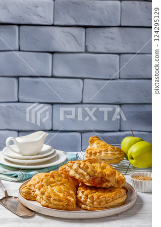 puff pastry apple turnovers on a plate 124295129