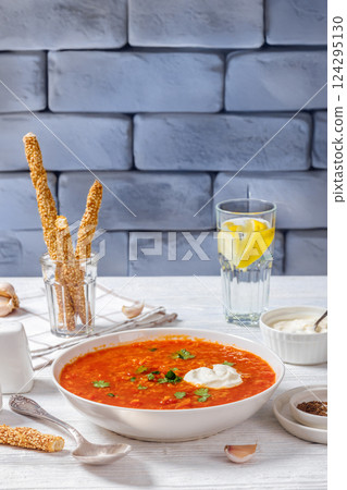 Red Lentil Tomato Soup with sour cream in a bowl 124295130