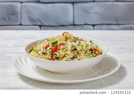 quinoa salad with veggies, cheese, olives in bowl quinoa salad with veggies, cheese, olives in bowl 124295132