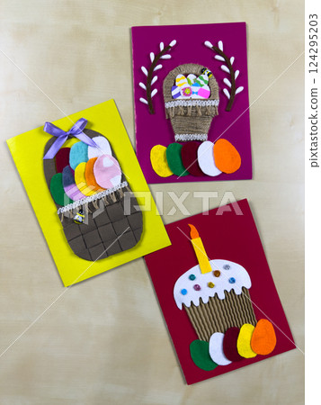 Charming handmade Easter card trio with vibrant basket and cake designs 124295203