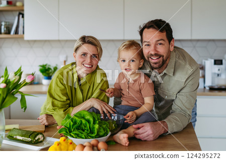 Family preparing lettuce salad to celebrate Easter Green Thursday 124295272