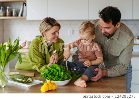 Family preparing lettuce salad to celebrate Easter Green Thursday 124295273