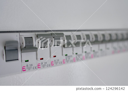 Electrical panel with row of circuit breakers in fuse box 124296142