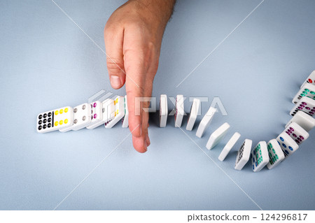 Stopping falling dominoes in a conceptual image of business crisis management 124296817
