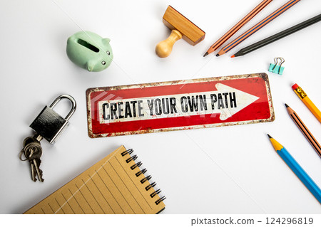 Create your own path. Red direction arrow with text on white office desk Create your own path. Red direction arrow with text on white office desk 124296819