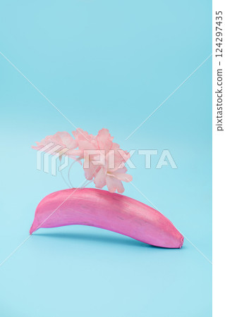 Colorful arrangement of pink banana and soft flowers on a blue background 124297435
