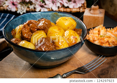 Beef stew in gravy, served with silesian dumplings. Beef stew in gravy, served with silesian dumplings. 124297923
