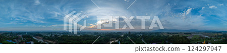 Aerial view of Clouds streak the sunlight above unban village. 124297947