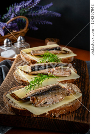 Sandwich with sprats and cheese. Sandwich with sprats and cheese. 124297948