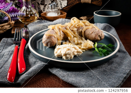 Fried white sausage with onions. 124297956