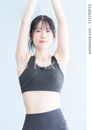 A woman doing yoga exercises during training A woman doing yoga exercises during training 124298018