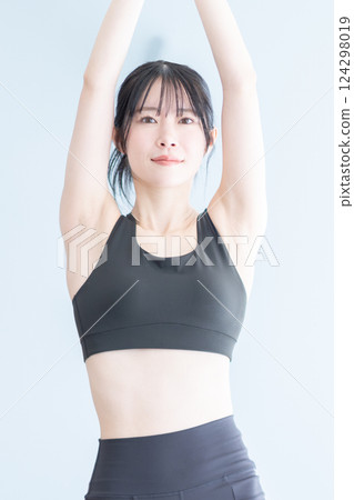 A woman doing yoga exercises during training 124298019