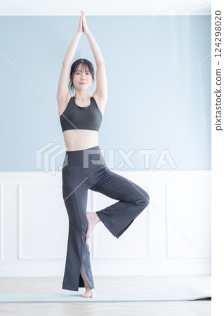 A woman doing yoga exercises during training A woman doing yoga exercises during training 124298020