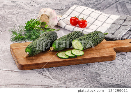 Raw green cucumbers with slices 124299011